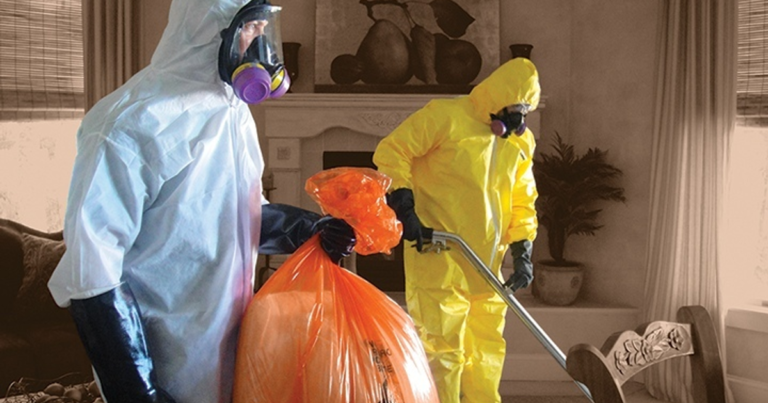 two crime scene cleaners cleaning a crime scene, one is vacuuming and the other one is holding a bag of trash they collected.